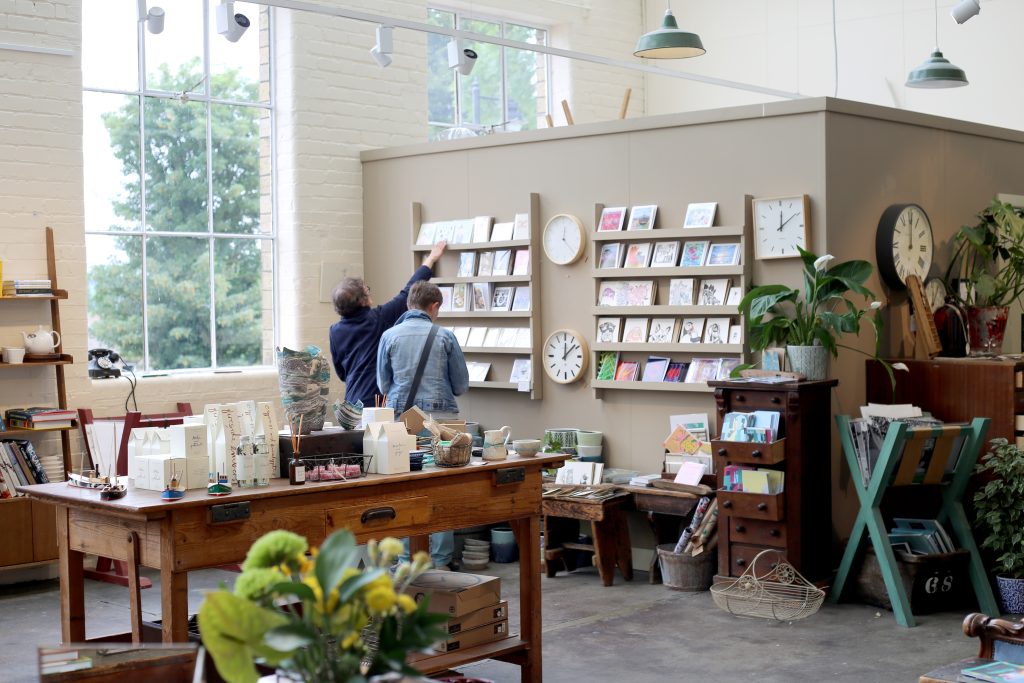 Two people browsing in a very light, airy looking shop.