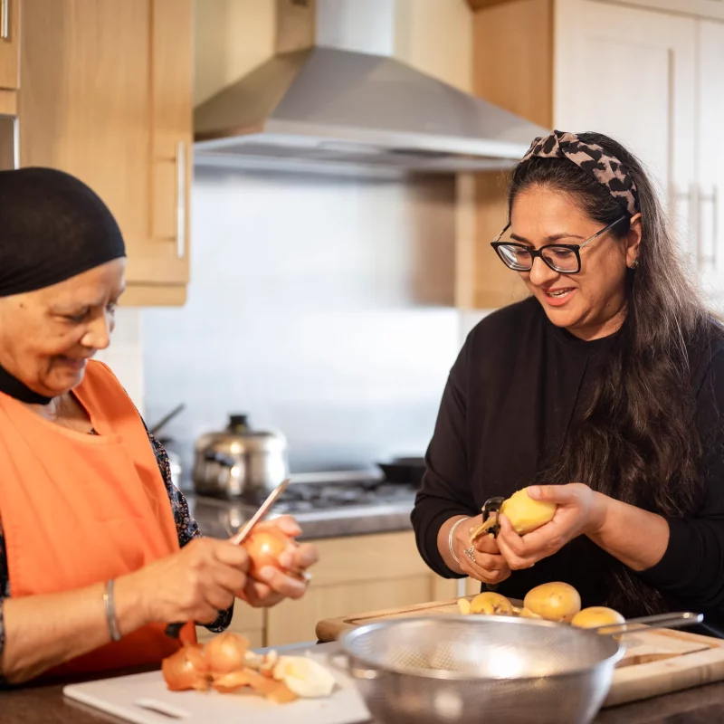 Two women working together in a kitchen.